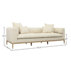 Canapé beige capitonné avec quatre coussins