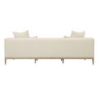 Canapé beige capitonné avec quatre coussins
